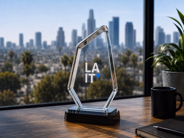 Crystal LA IT award trophy on a desk overlooking the downtown Los Angeles skyline